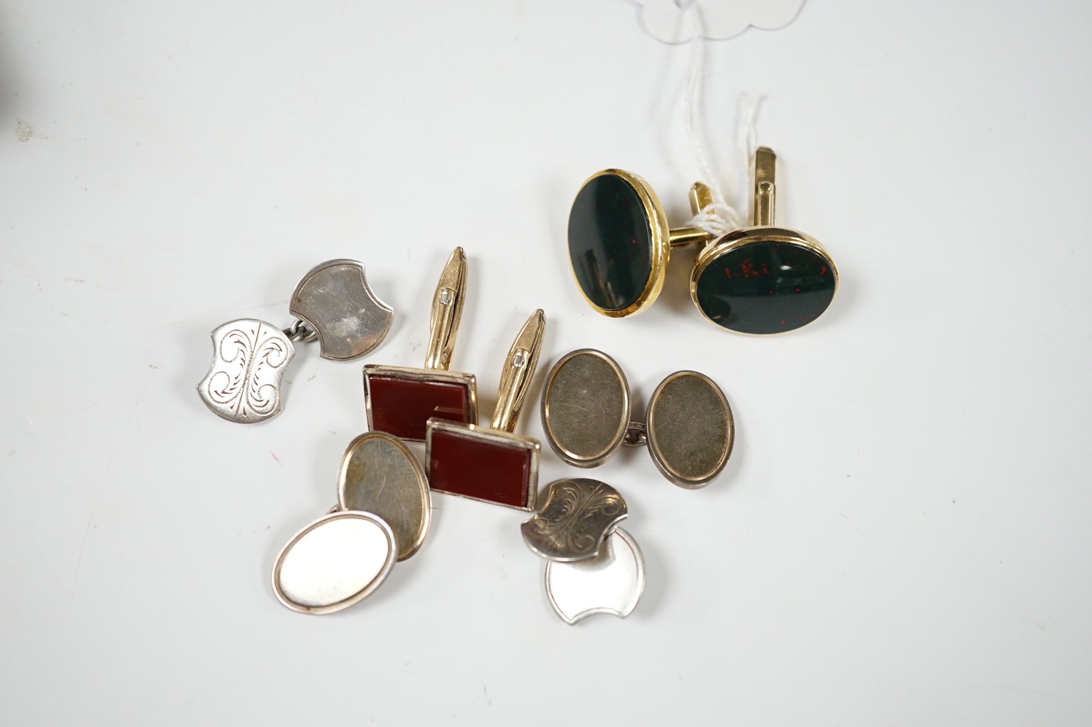 A modern pair of 9ct gold and bloodstone set oval cufflinks, 23mm, gross weight 12.6 grams, together with three other pairs of cufflinks including silver and 'gold on silver'. Condition - fair to good